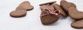 Heart shaped cookies decorated with red and white twine