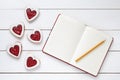 Heart shaped cookies with empty notebook frame and pencil composition for Valentines Day