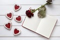 Heart shaped cookies with empty notebook frame and red rose gift composition for Valentines Day