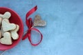 Heart shaped cookies in red plate on gray concrete backdrop. Valentine`s day homemade treats. Royalty Free Stock Photo