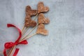 Heart shaped cookies on a stick on a white background. Overhead view of homemade Valentines treats. Creative gift. Royalty Free Stock Photo