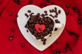 Heart shaped cup with coffee beans on red Royalty Free Stock Photo
