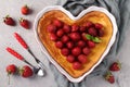 Heart-shaped curd casserole decorated with strawberries, close-up, top view