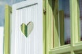 Heart-shaped cutout on window wooden shutter Royalty Free Stock Photo