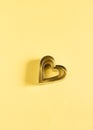 Heart-shaped cutters on an yellow paper background Royalty Free Stock Photo