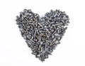 A heart shaped figure laid out from various assorted rusty metal old bolts, screws, nails, nuts. The concept of metallic Royalty Free Stock Photo