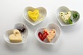 Heart shaped flavored butter pats in matching bowl Royalty Free Stock Photo
