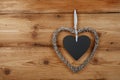 Heart shaped frame with blackboard on wooden wall Royalty Free Stock Photo