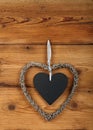 Heart shaped frame with blackboard on wooden wall Royalty Free Stock Photo