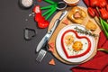 Heart-shaped fried egg served with toasted bread. Romantic art food idea for Valentine\'s breakfast Royalty Free Stock Photo