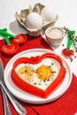 Heart-shaped fried egg served with toasted bread. Romantic art food idea for Valentine\'s breakfast Royalty Free Stock Photo