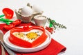 Heart-shaped fried egg served with toasted bread. Romantic art food idea for Valentine\'s breakfast Royalty Free Stock Photo