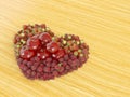 Heart shaped fruits lay in the wooden floor