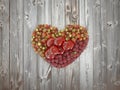 Heart shaped fruits with wooden background