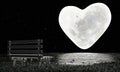 Heart-shaped full moon with full stars in the sky. Moon reflected on water`s surface. long bench made of wood on the grass with Royalty Free Stock Photo