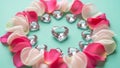 Heart-shaped gemstones surrounded by rose petals Royalty Free Stock Photo