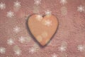 Heart shaped gingerbread cookie on terracotta wall snowflower Royalty Free Stock Photo