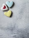 Heart shaped gingerbread cookies with colourful yellow and blue glazing on grey background with copy space. Royalty Free Stock Photo