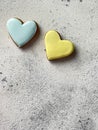 Heart shaped gingerbread cookies with colourful yellow and blue glazing on grey background with copy space. Royalty Free Stock Photo