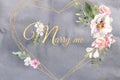 Heart shaped golden frames with marry me text watercolor flowers