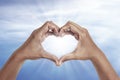 Heart shaped hand with blue sky background Royalty Free Stock Photo