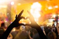 Fan made heart shaped hands with lights in music concert Royalty Free Stock Photo