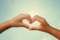 Heart shaped hands with noon sun and sky instagram Royalty Free Stock Photo