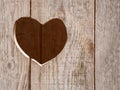 A heart shaped hole cut in a wooden door Royalty Free Stock Photo