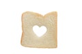 Heart shaped hole in a slice of bread isolated Royalty Free Stock Photo