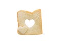 Heart shaped hole in a slice of bread isolated Royalty Free Stock Photo