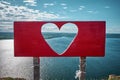 Heart-shaped hole. View of the sunny sky and the sea bay Royalty Free Stock Photo