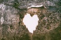 Heart-shaped hole in the wall of an old ruined house Royalty Free Stock Photo