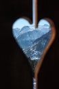 through a heart-shaped hole in the wall you can see the mountains Royalty Free Stock Photo