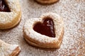 Heart shaped homemade Linzer Christmas cookie filled with red strawberry marmalade and dusted with sugar, closeup Royalty Free Stock Photo