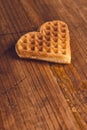 Heart shaped homemade waffle on wooden desk