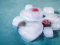 Heart shaped ice cubes with frozen cherry Royalty Free Stock Photo