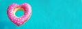 Heart shaped inflatable ring floating in swimming pool on sunny day, above view with space for text. Banner Royalty Free Stock Photo