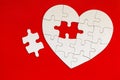 Heart-shaped jigsaw puzzle on color background. Puzzle heart on wooden background. A missing piece of the heart puzzle. Heart Royalty Free Stock Photo