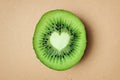 Heart shaped kiwi on recycled paper background - Kiwi is good for heart health Royalty Free Stock Photo