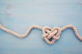 Heart shaped knot on blue wooden background Royalty Free Stock Photo