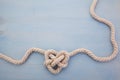 Heart shaped knot on blue wooden background