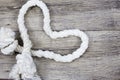 Heart Shaped Knot on a rope on wooden background.