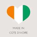 Heart shaped label with Ivory Coast flag. Made in Cote D`ivoire Sticker. Factory, manufacturing and production country concept.