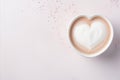 Heart shaped latte art on a cup of creamy coffee, top viewLove themed backdrop for romantic moments.