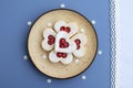 Heart shaped linzer cookies filled with strawberry jam, decorative small sugar snowflakes around Royalty Free Stock Photo
