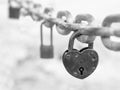 Heart-shaped lock hangs from the bridge chain. The wedding custom is a symbol of eternal love.