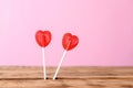 Heart shaped lollipops on color background, space for text Royalty Free Stock Photo