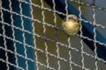 Heart shaped love padlock attatched to wire fence on a bridge. T