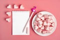 Heart-shaped marshmallow, white notepad, flamingo pen on a pink background Happy Valentine`s Day Royalty Free Stock Photo