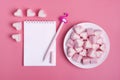 Heart-shaped marshmallow, white notepad, flamingo pen on a pink background Happy Valentine`s Day Royalty Free Stock Photo